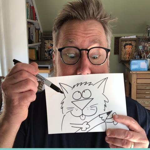 Artist Rick Stromoski holding a sketch.
