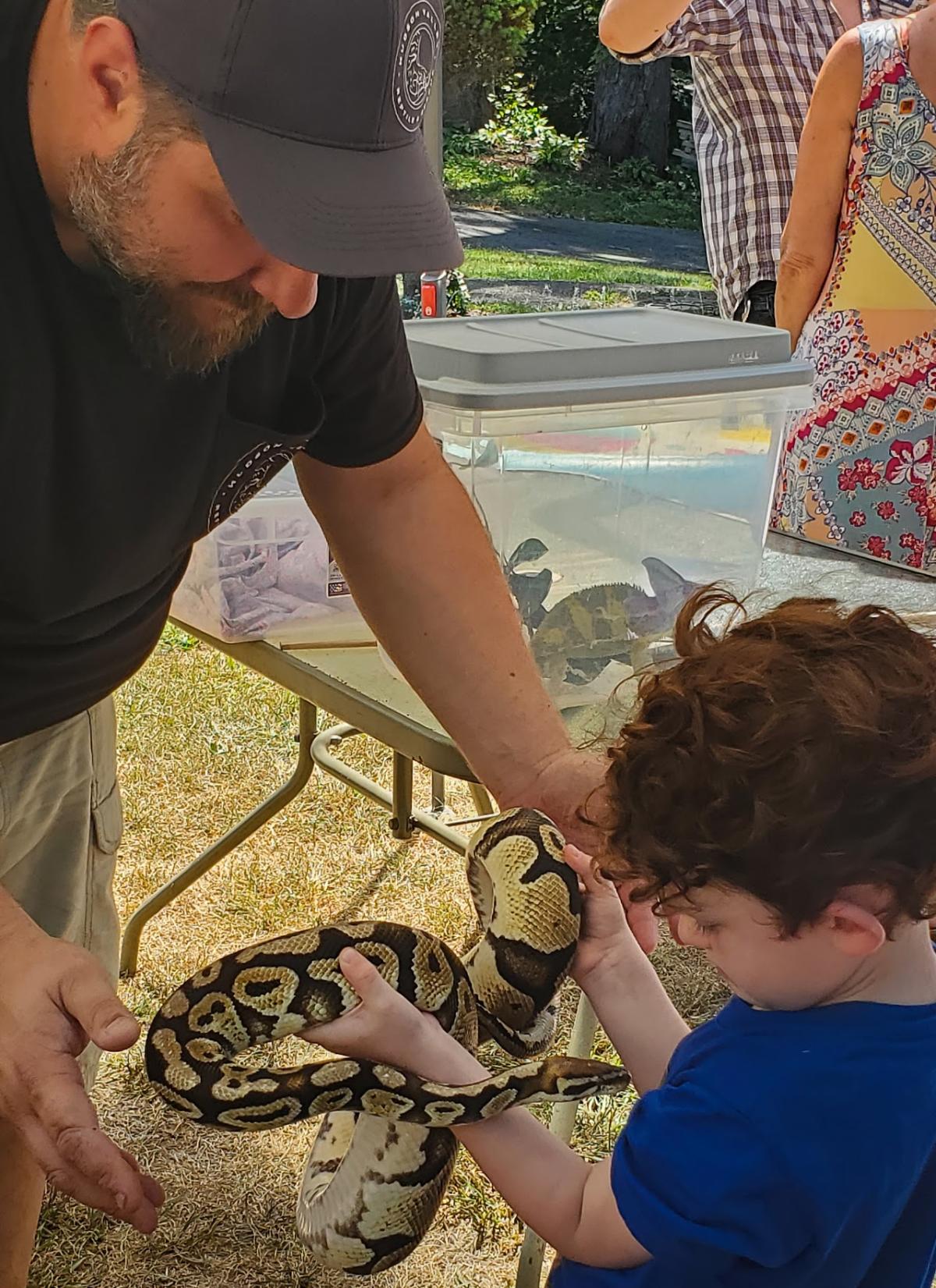 man and child with snake